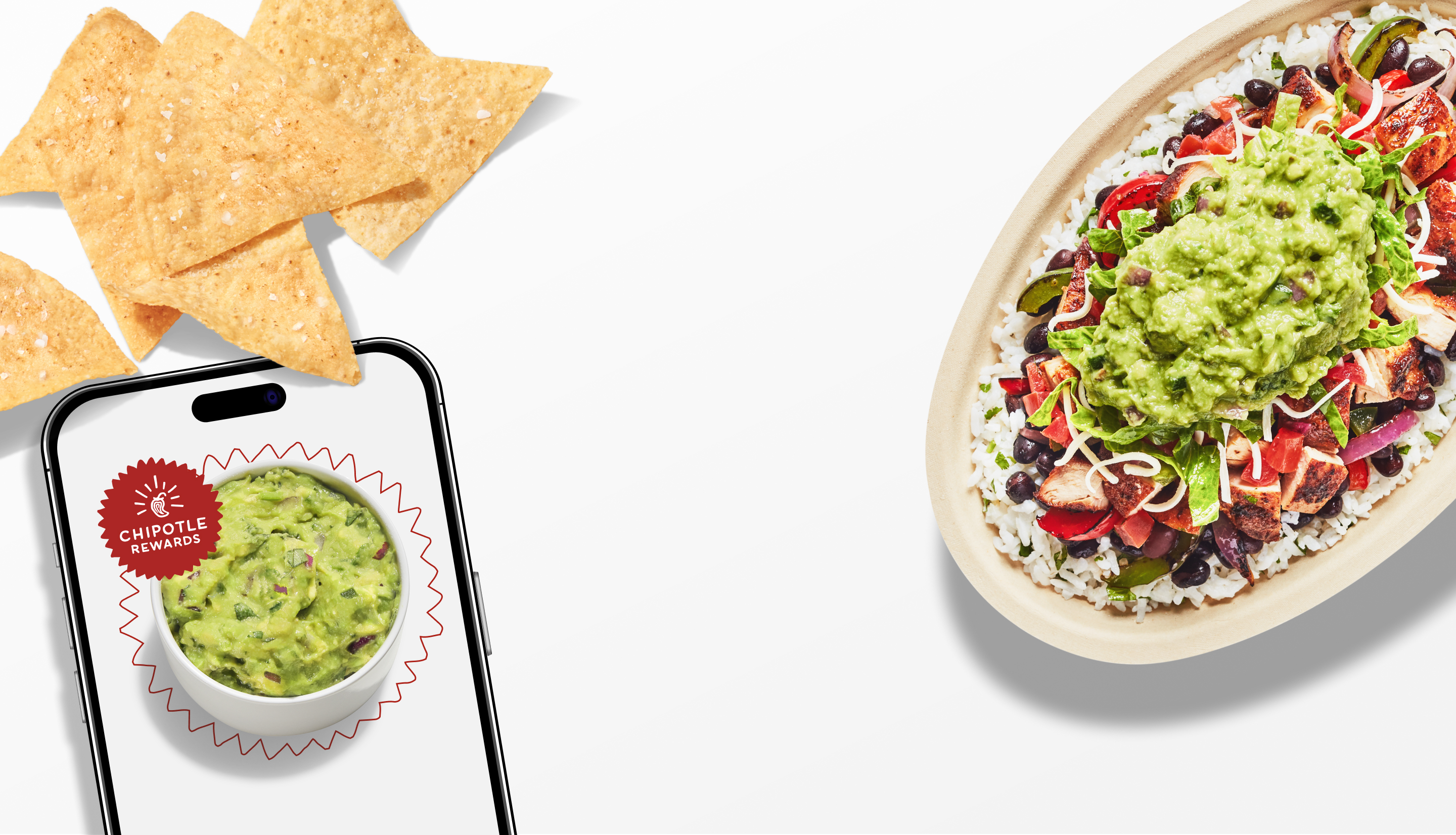 A Chicken Burrito Bowl with White Rice, Black Beans, Fajita Veggies, Fresh Tomato Salsa, Lettuce, and Guacamole with a side of freshly made Tortilla Chips and a side of Guac.